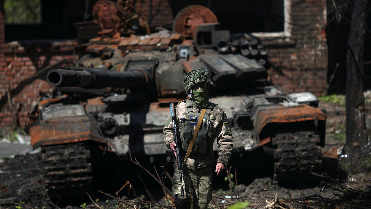 Photo: A Ukrainian soldier poses next to a destroyed Russian tank in Malaya Rohan village, amid Russia's attack on Ukraine, near Kharkiv, Ukraine, May 5, 2022. Credit: REUTERS/Ricardo Moraes