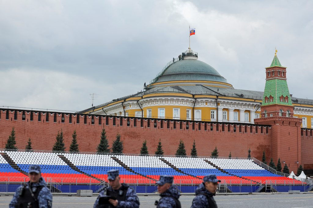 Photo: Russian law enforcement officers stand guard in Red Square, with people seen on the dome of the Kremlin Senate building in the background, in central Moscow, Russia, May 3, 2023. Credit: REUTERS/Evgenia Novozhenina/File Photo