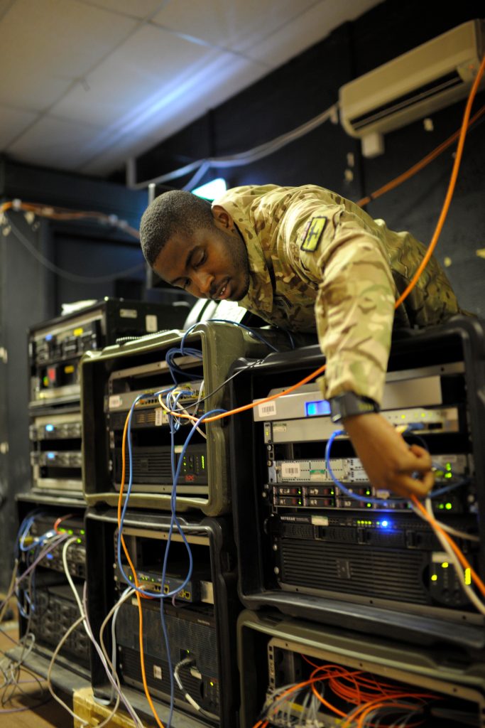 Photo: British Army soldier checks computer server equipment. Credit: ipm / Alamy Stock Photo.