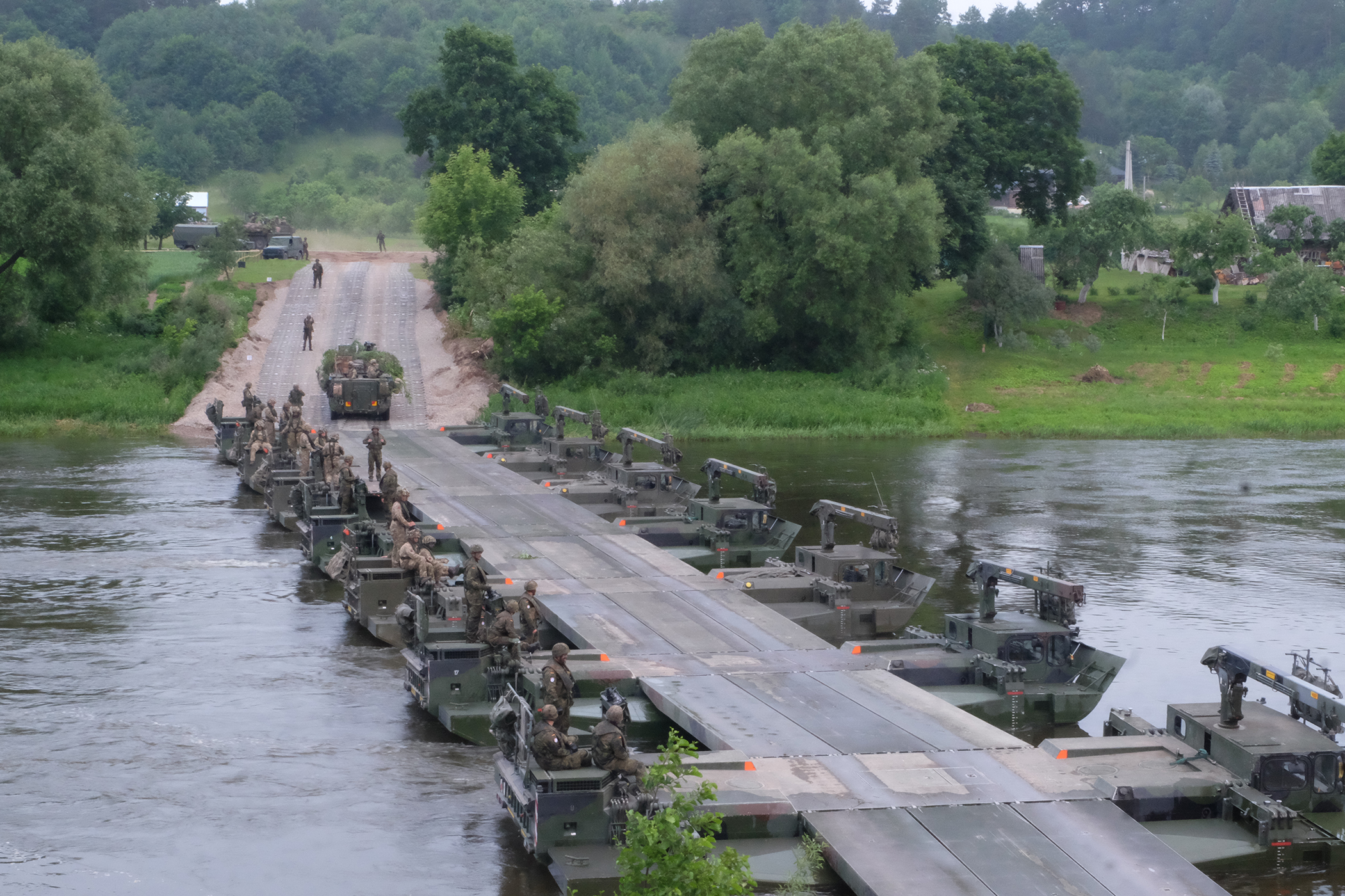 Battle Group Poland U.S., U.K and 15th Mechanized Brigade Polish tactical vehicles perform river crossing training June 19 in Rukla, Lithuanian as part of the joint training exercise Iron Wolf which is held in conjunction with Saber Strike 17. The exercises include integrated and synchronized deterrence-oriented training designed to improve interoperability and readiness of the militaries of the 20 participating nations throughout the Baltic region and Poland. (U.S. Army photo by Spc. Kevin Wang/Released)