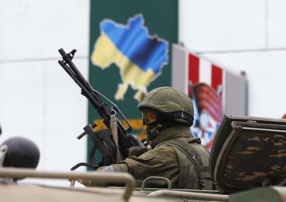 Photo: An armed serviceman looks out from a Russian army vehicle outside a Ukrainian border guard post in the Crimean town of Balaclava March 1, 2014. Ukraine accused Russia on Saturday of sending thousands of extra troops to Crimea and placed its military in the area on high alert as the Black Sea peninsula appeared to slip beyond Kiev's control. Credit: REUTERS/Baz Ratner