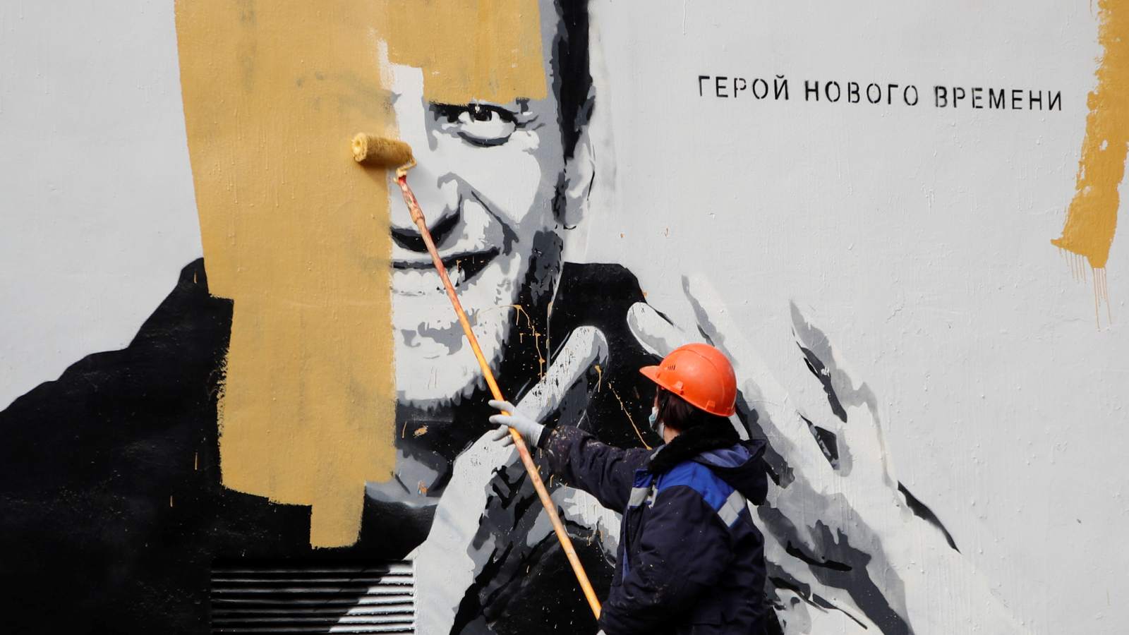 Photo: A worker paints over a graffiti depicting jailed Russian opposition politician Alexei Navalny in Saint Petersburg, Russia April 28, 2021. The graffiti reads: "The hero of the new age". Credit: REUTERS/Anton Vaganov