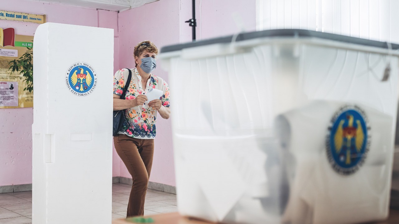 Photo: A voter casts her vote at a polling station in Chisinau during the parliamentary elections. Credit: Diego Herrera / SOPA Images/Sipa USA.