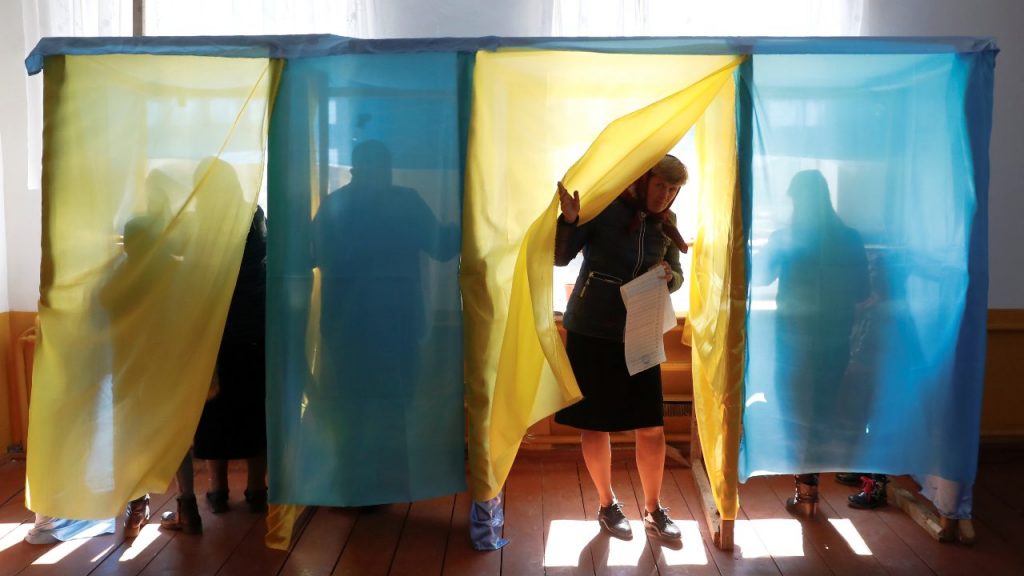 Photo: A woman walks out of a voting booth at a polling station during a presidential election in the village of Kosmach in Ivano-Frankivsk Region, Ukraine March 31, 2019. Credit: REUTERS/Kacper Pempel