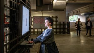 Photo: A woman explores an interactive exhibit on facial recognition and bias. Credit: Jürgen Grünwald/Creative Commons