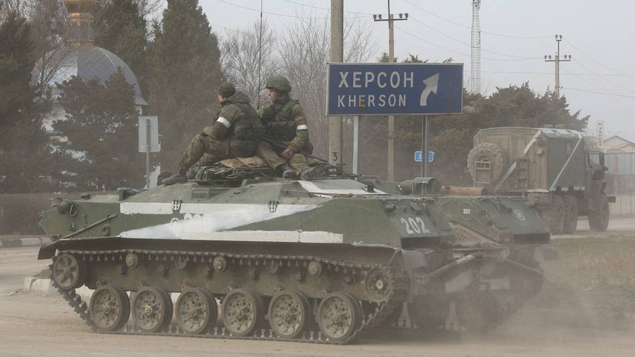 Photo: Servicemen ride on a Russian Army military armored vehicle with the letter 'Z' on it, after Russian President Vladimir Putin authorized a military operation in eastern Ukraine, in the town of Armyansk, Crimea, February 24, 2022. Credit: REUTERS/Stringer