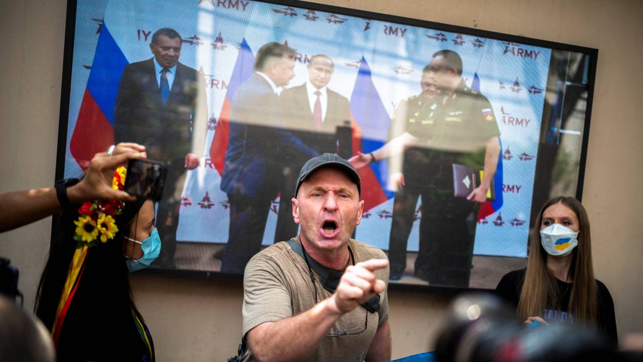 Photo: Ukrainians living in Bangkok and their supporters speak in front of a TV screen showing a video presentation of Russian President Vladimir Putin as they take part in an anti-war protest during Russia's invasion of Ukraine, outside the Russian embassy in Bangkok, Thailand March 1, 2022. Credit: REUTERS/Athit Perawongmetha.