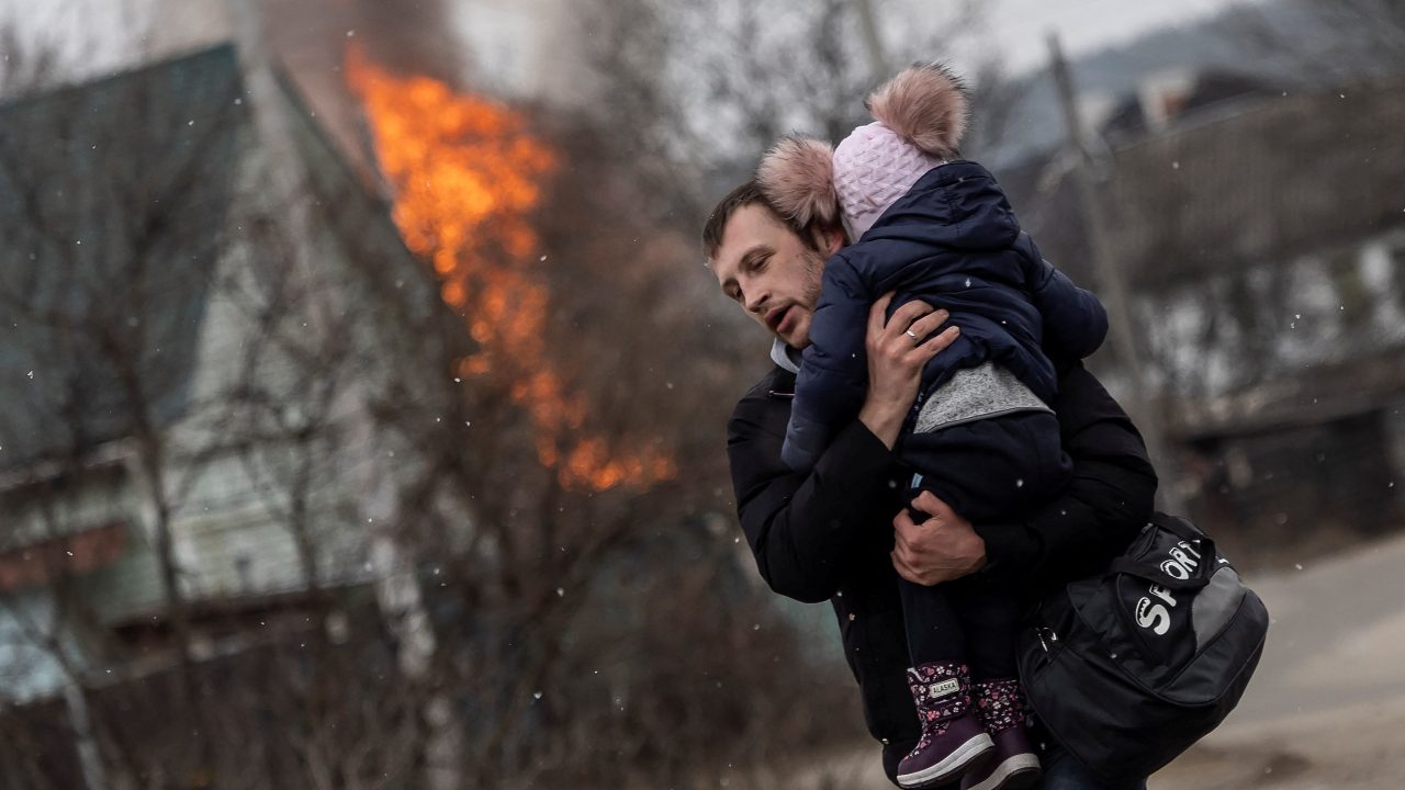 Photo: A man and a child escape from the town of Irpin, after heavy shelling on the only escape route used by locals, while Russian troops advance towards the capital of Kyiv, in Irpin, near Kyiv, Ukraine March 6, 2022. Credit: REUTERS/Carlos Barria