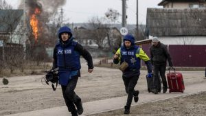 Photo: Journalists run for cover after heavy shelling on the only escape route used by locals, while Russian troops advance towards the capital, in Irpin, near Kyiv, Ukraine March 6, 2022. Credit: REUTERS/Carlos Barria