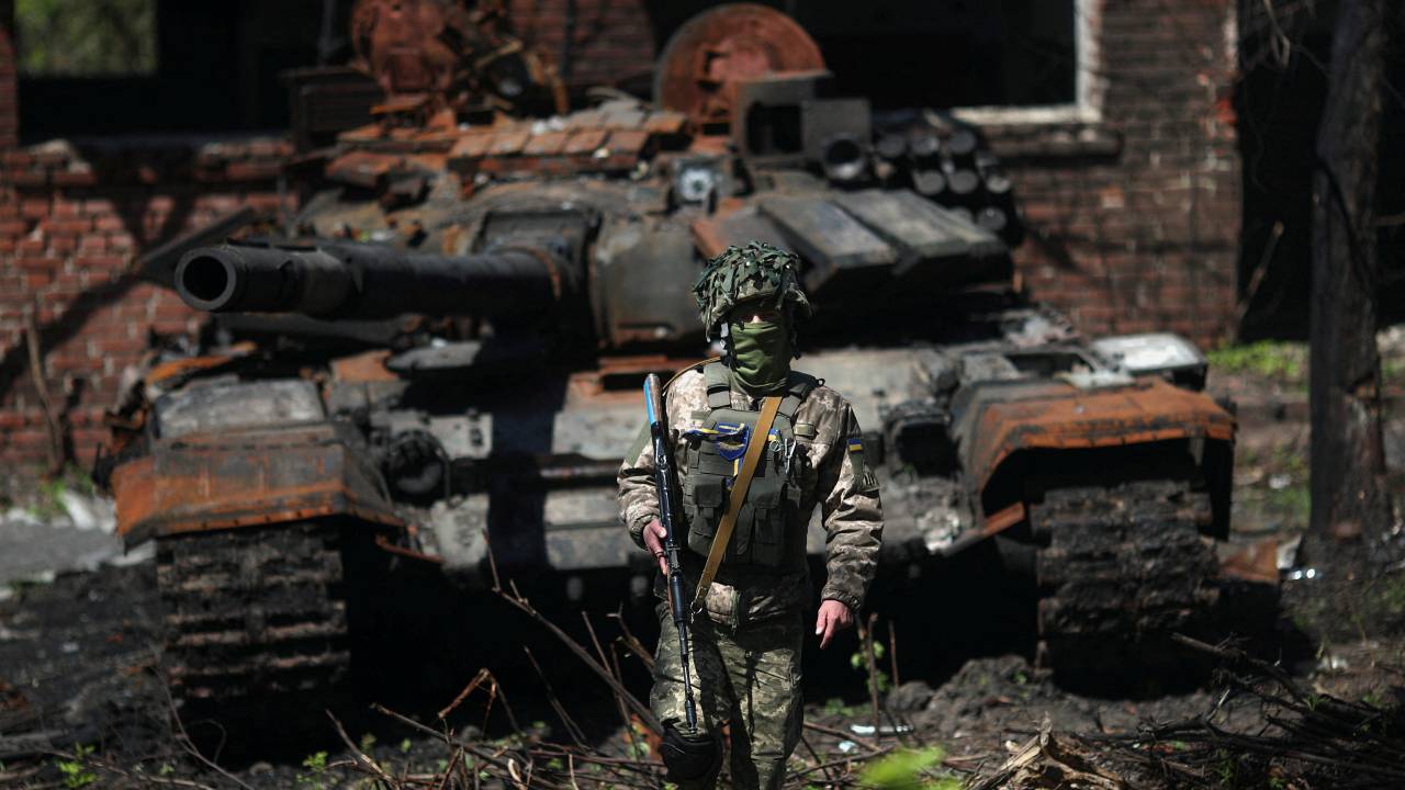 Photo: A Ukrainian soldier poses next to a destroyed Russian tank in Malaya Rohan village, amid Russia's attack on Ukraine, near Kharkiv, Ukraine, May 5, 2022. Credit: REUTERS/Ricardo Moraes.
