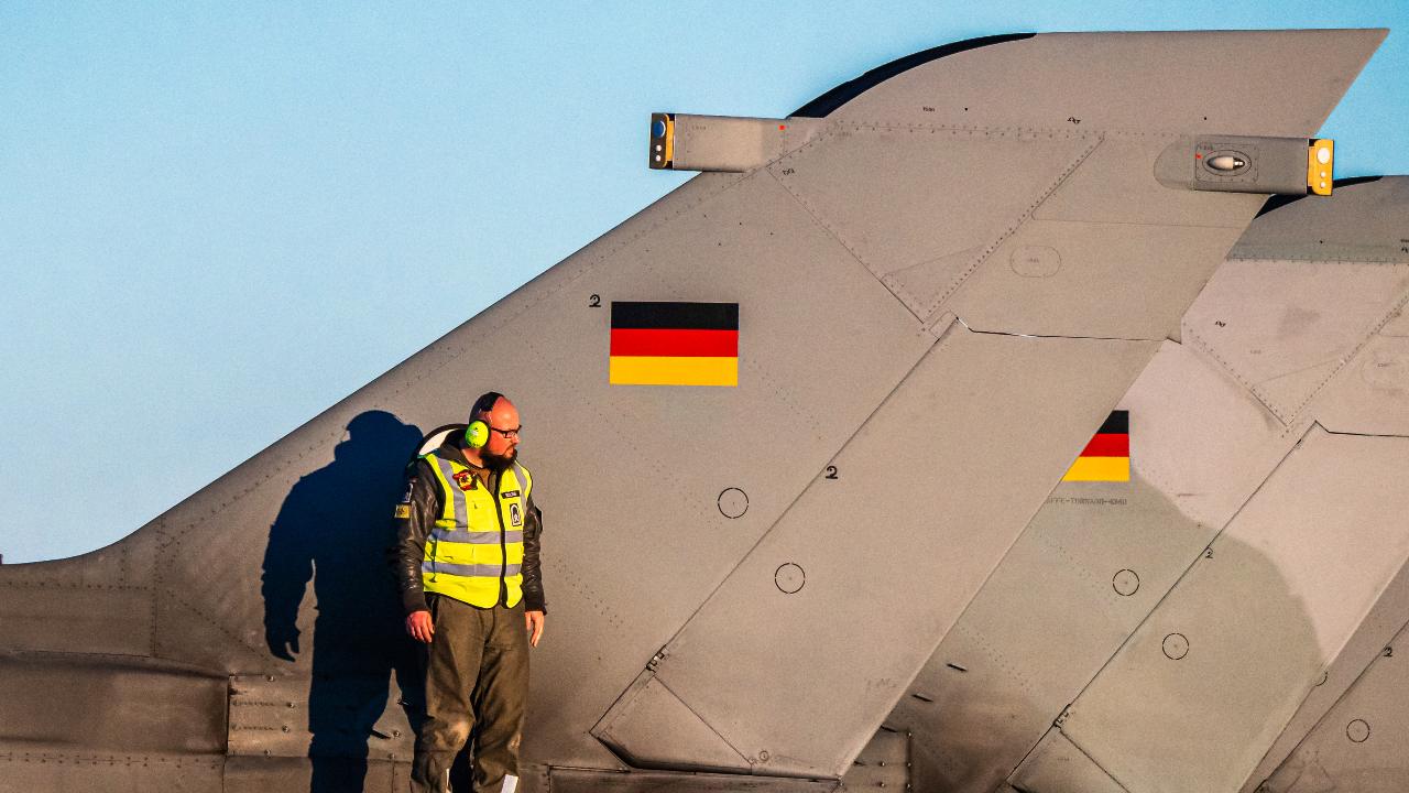 Photo: A German Air Force maintainer stands of the fuselage of a Tornado fighter-bomber at Los Llanos Air Base in Albacete, Spain on 29 November 2021 as part of a flying course hosted by the Tactical Leadership Programme. Credit: NATO via Flickr.