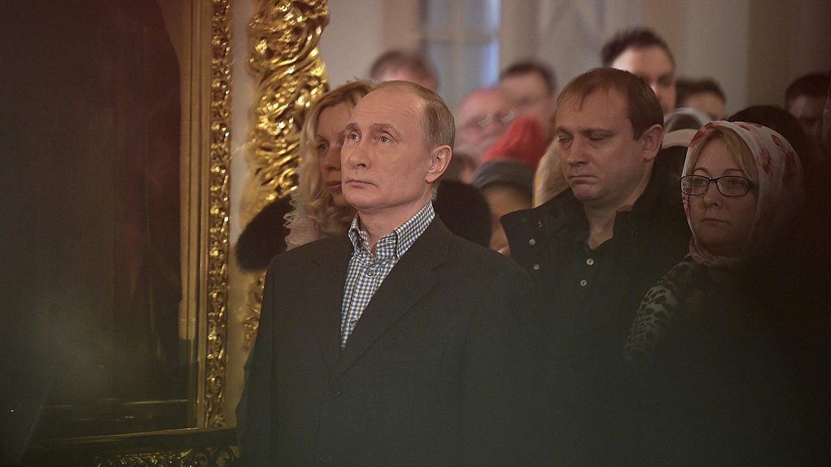 Photo: Vladimir Putin at Christmas service at the Church of Simeon and Anna (St. Petersburg; 2018-01-07. Credit: kremlin.ru via Wikimedia.