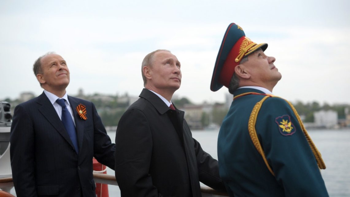 Photo: Russian President Vladimir Putin (C), Russia's Defence Minister Sergei Shoigu (R) and Russia's Federal Security Service (FSB) Director Alexander Bortnikov watch events marking Victory Day, in Sevastopol May 9, 2014. Putin flew in to Crimea on Friday, marking the Soviet victory in World War Two and proclaiming the success of the peninsula's seizure from an Ukraine that Russia says has been taken over by fascists. Credit: REUTERS/Alexei Druzhinin/RIA Novosti/Kremlin via REUTERS