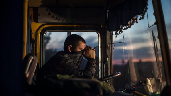 Photo: A driver sits inside a bus during an exchange of prisoners-of-war (POWs) near Donetsk, eastern Ukraine, September 21, 2014. The two sides, that of the government forces and the pro-Russian separatists, are exchanging POWs under the terms of the current ceasefire. Credit: REUTERS/Marko Djurica