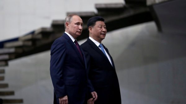 Russia's President Vladimir Putin and China's Xi Jinping walk down the stairs as they arrive for a BRICS summit in Brasilia, Brazil November 14, 2019.