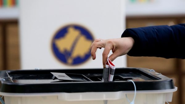 Photo: A voter casts a ballot during parliamentary elections in Pristina, Kosovo, February 14, 2021. Credit: REUTERS/Florion Goga