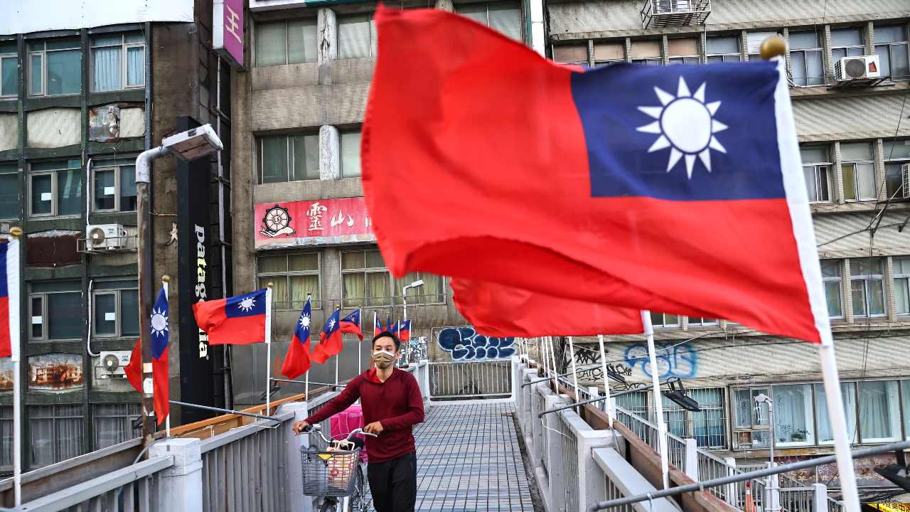 Photo: A man walks on an overpass decorated with Taiwan flags to celebrate the upcoming National Day in Taipei, Taiwan, October 7, 2021. Credit: REUTERS/Ann Wang