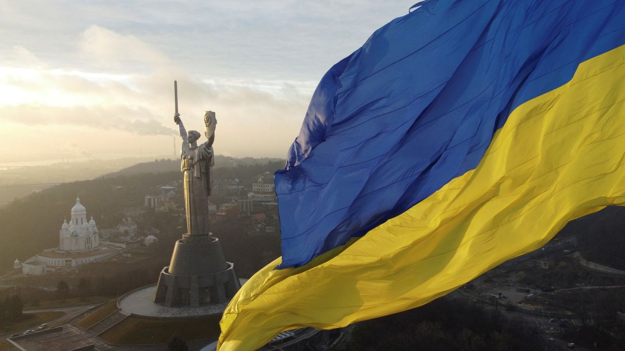 Photo: Ukraine's biggest national flag on the country's highest flagpole and the giant 'Motherland' monument are seen at a compound of the World War II museum in Kyiv, Ukraine, December 16, 2021. Credit: The picture was taken with a drone. REUTERS/Valentyn Ogirenko.