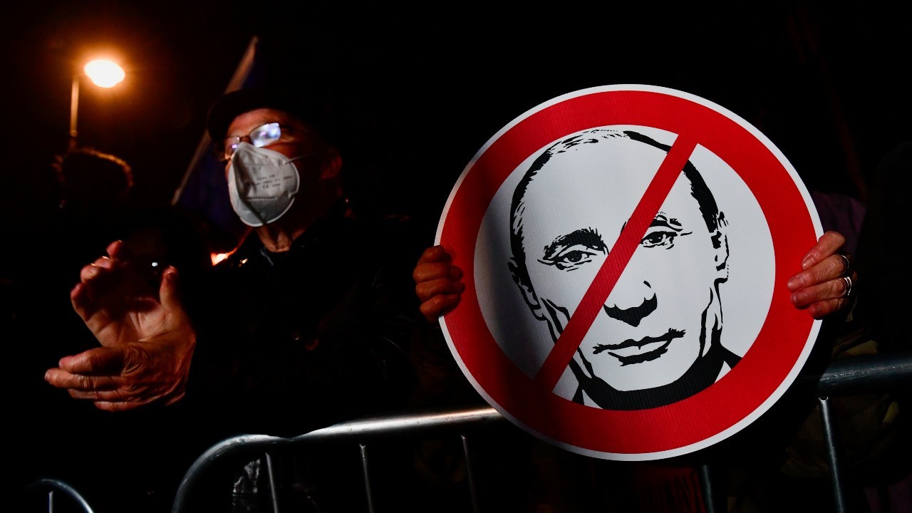 Photo: A person holds a sign during a protest organised by Hungary's opposition members, outside the headquarters of the Moscow-backed International Investment Bank, after Russia's invasion of Ukraine, in Budapest, Hungary March 1, 2022. Credit: REUTERS/Marton Monus