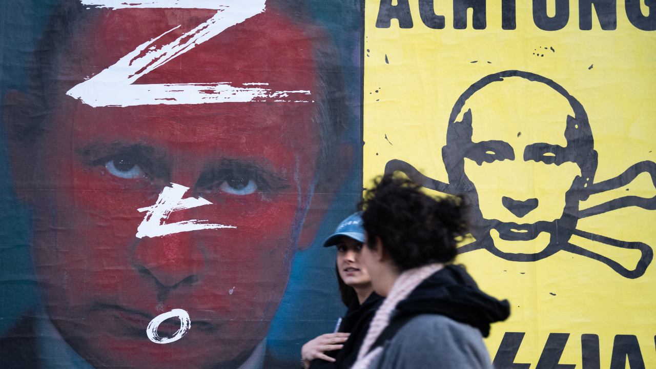 Photo: People walks past of anti-Putin posters in Warsaw, Poland, on March 21, 2022. Credit: Annabelle Chih/NurPhoto