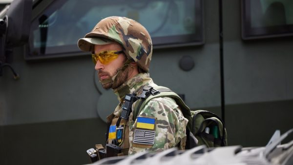 Photo: An Ukrainian soldier stands guard as president Volodymyr Zelenskiy visited the city of Mykolaiv on the Black Sea coast on Saturday June 18, 2022. His visit followed a military strike on Mykolaiv on Friday, which killed at least two people, according to the Mykolaiv regional administration. Images released by the Presidential office showed Zelenskiy, alongside the head of the regional military administration Vitaliy Kim and his team of officials visiting the ruins of the administration's building. The building was destroyed by Russian shelling in April, which killed at least 34 people. The Ukrainian President also presented medals and honors to Kim, other regional army officials and fighters. Credit: Eyepress Media via Reuters.