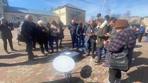 Caption: Civilians in the village of Ivankiv, Kyiv region, regain access to internet with the arrival of a Starlink system, in April 2022. Credit: Mykhailo Fedorov/Twitter.
