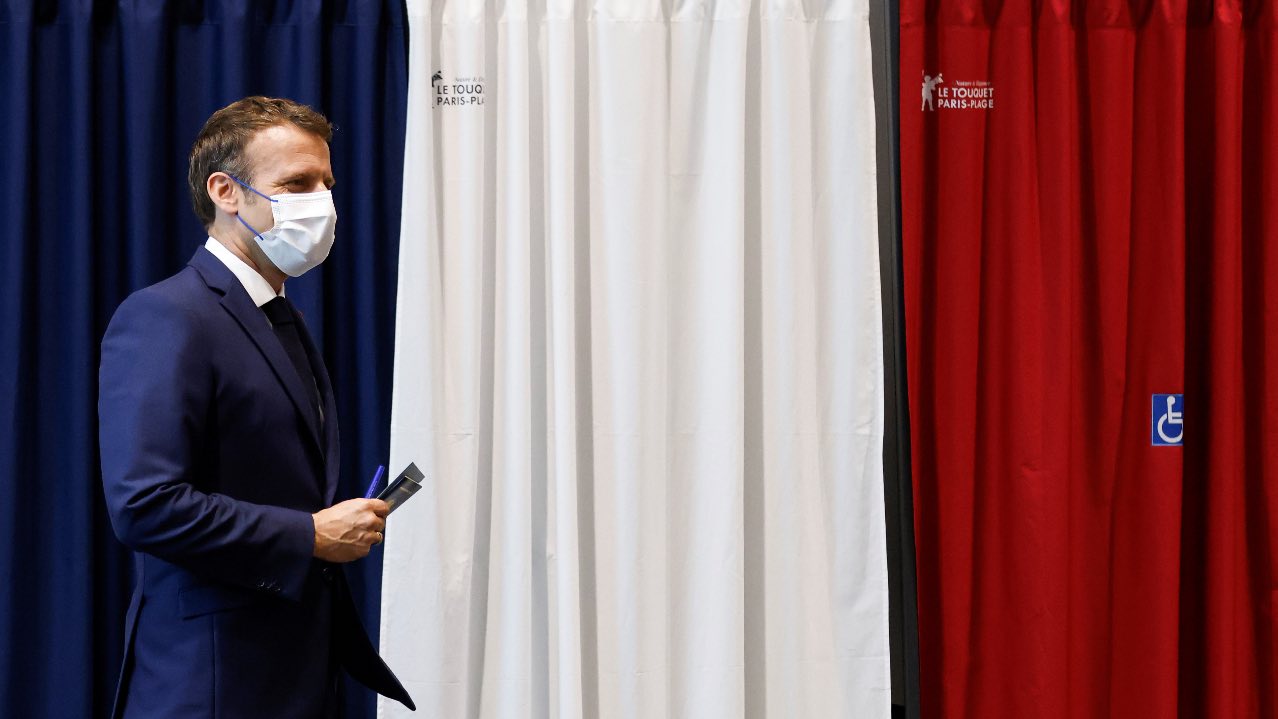 Photo: French President Emmanuel Macron leaves a booth equipped with anti-COVID curtains at a polling station in Le Touquet, France during the second round of regional elections on June 27, 2021. Credit: Ludovic Marin/Pool via REUTERS.
