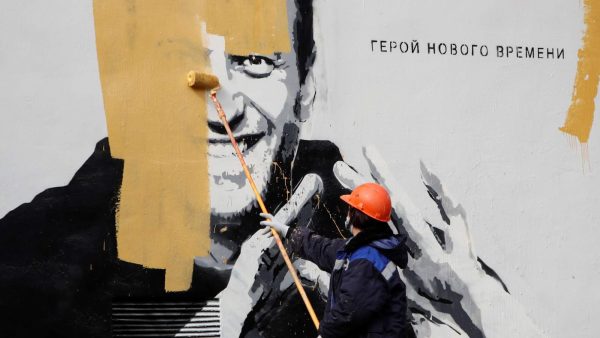 Photo: A worker paints over a graffiti depicting jailed Russian opposition politician Alexei Navalny in Saint Petersburg, Russia April 28, 2021. The graffiti reads: "The hero of the new age". Credit: REUTERS/Anton Vagano