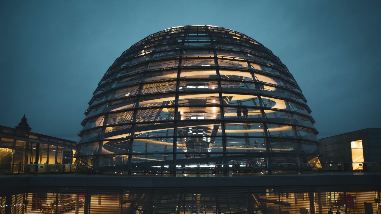 Photo: Dome of the German Bundestag on top of the Reichstag. Credit: Christian Lue / Unsplash