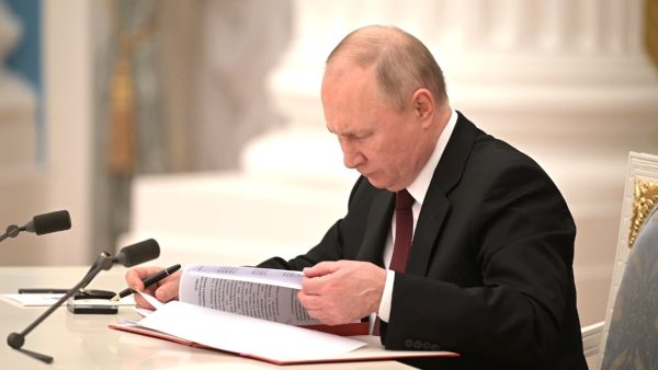 Photo: President Putin signs executive orders on recognizing the Donetsk and Lugansk people’s republics, as well as treaties on friendship, cooperation and mutual assistance in the Kremlin. Credit: Kremlin.ru
