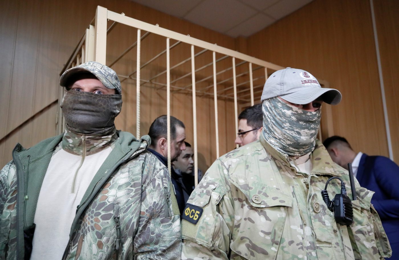Photo: Officers of Russia's FSB security service stand guard near a defendants' cage, with detained crew members of Ukrainian naval ships inside, during a court hearing in Moscow, Russia January 15, 2019. Credit: REUTERS/Maxim Shemetov