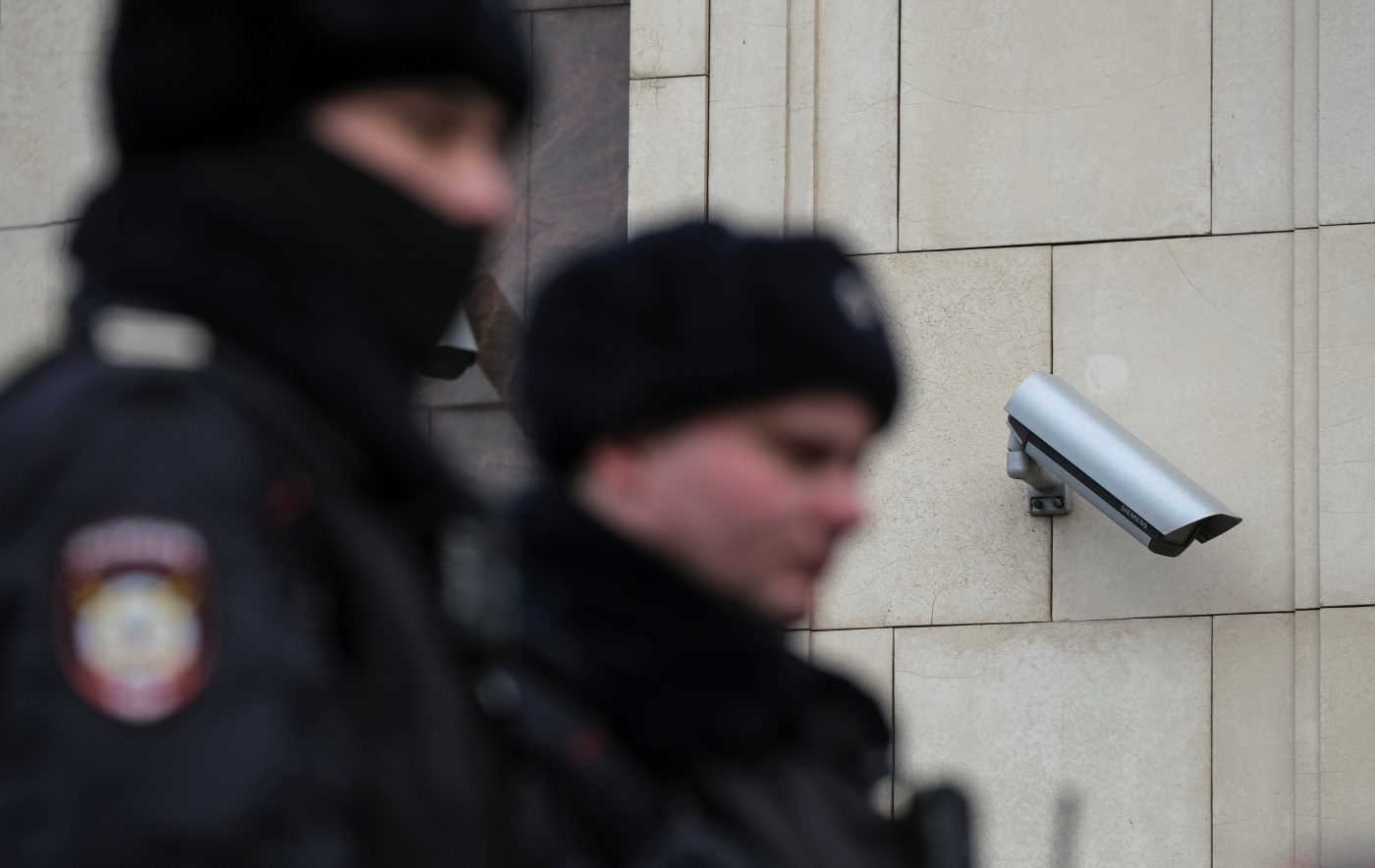 Photo: Police officers walk past a surveillance camera in central Moscow, Russia January 26, 2020. Picture taken January 26, 2020. Credit: REUTERS/Shamil Zhumatov
