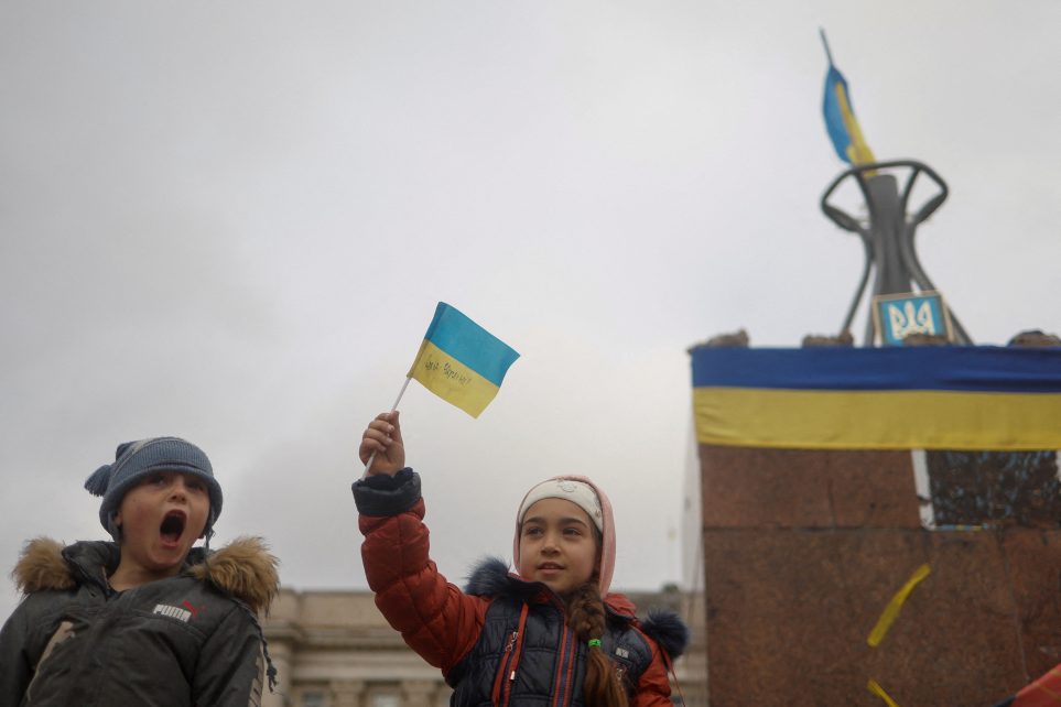 Photo: Children celebrate after Russia's retreat from Kherson, in central Kherson, Ukraine November 13, 2022. Credit: REUTERS/Valentyn Ogirenko.