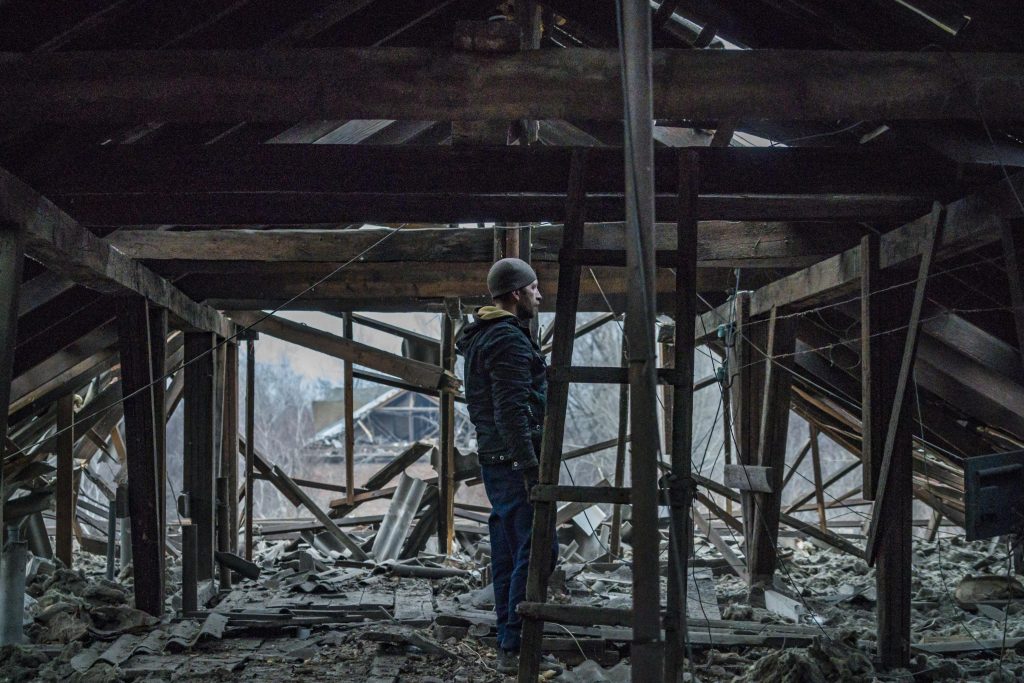 Photo: A man checks the roof of his home destroyed by the nearby rocket impact after a russian shelling over Kostiantynivka, Donetsk Oblast. Explosion made a huge devastation in the civilian buildings around. Credit: Celestino Arce/NurPhoto