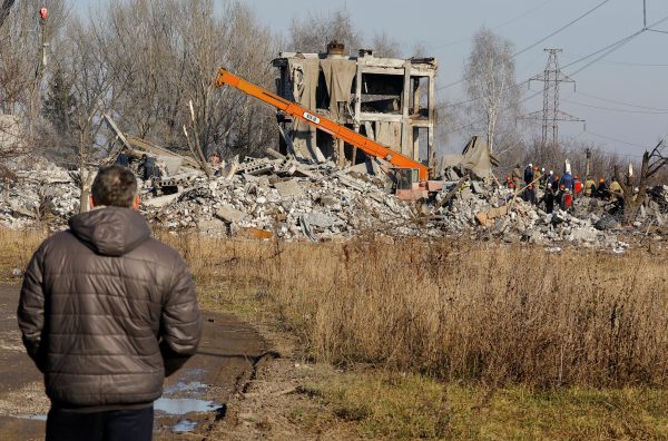 Photo: A man watches workers removing debris of a destroyed building purported to be a vocational college used as temporary accommodation for Russian soldiers, 63 of whom were killed in a Ukrainian missile strike as stated the previous day by Russia's Defence Ministry, in the course of Russia-Ukraine conflict in Makiivka (Makeyevka), Russian-controlled Ukraine, January 3, 2023. Credit: REUTERS/Alexander Ermochenko