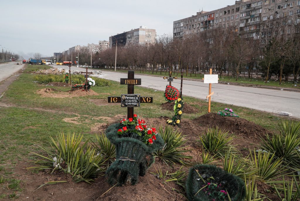 Photo: Graves of civilians killed during Ukraine-Russia conflict are seen next to apartment buildings in the southern port city of Mariupol, Ukraine April 10, 2022. Credit: REUTERS/Alexander Ermochenko/File Photo