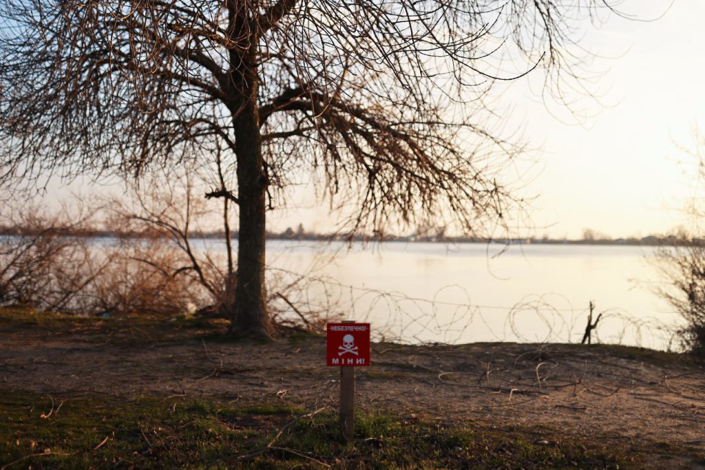 Photo: A view of a mine danger sign in front of Dnipro river, amid Russia's invasion of Ukraine, in Kherson, Ukraine, January 25, 2023. Credit: REUTERS/Nacho Doce