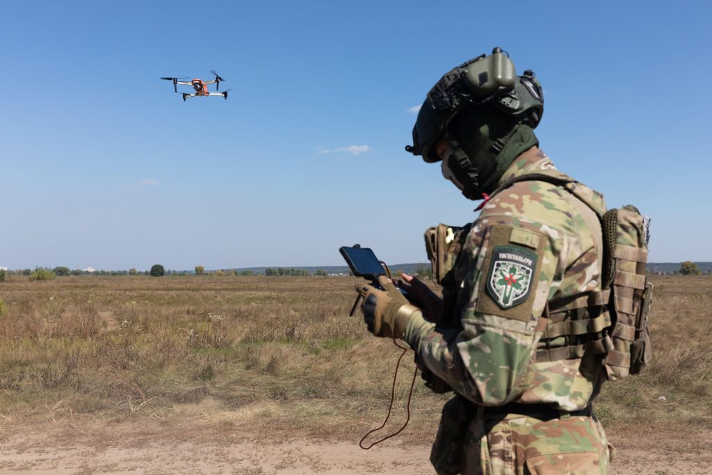 Photo: A drone operator launches a quadcopter to monitor the operation of an evacuation robot during its field testing. Credit: Mykhaylo Palinchak/SOPA Images via ZUMA Press Wi