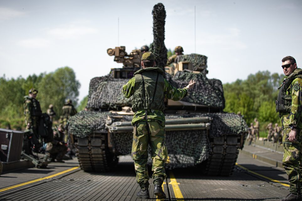 Photo: A Swedish soldier guides a U.S. Army M1A2 Abrams tank. Credit: U.S. Army National Guard photo by Sgt. Agustín Montañez) via dvids