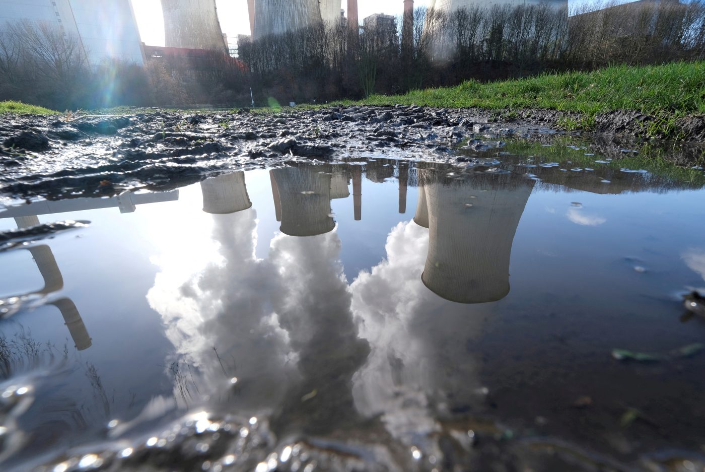 Photo: The lignite (brown coal) power plant complex of German energy supplier and utility RWE is reflected in a puddle in Neurath, north-west of Cologne, Germany, February 5, 2020. Credit: REUTERS/Wolfgang Rattay//File Photo