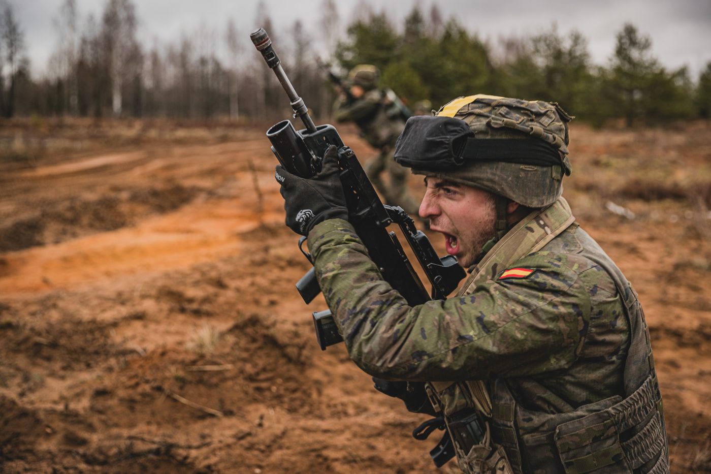 Photo: NATO’s battlegroup in Latvia tested its combat readiness during exercise Crystal Arrow 2023 A soldier from the Spanish Army yelling and running across the field during exercise Crystal Arrow 2023 in Latvia. Credit: NATO