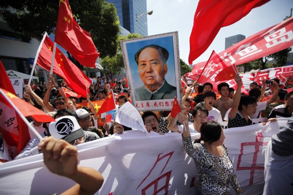 Photo: Protesters hold posters of China's late Chairman Mao Zedong and Chinese national flags as they shout slogans near the Japanese consulate during a protest in Shanghai September 16, 2012. Angry anti-Japan protesters took to the streets of Chinese cities for a second day on Sunday, with Japan's prime minister urging Beijing to protect his country's companies and diplomatic buildings from fresh assaults over a territorial dispute. Credit: REUTERS/Aly Song