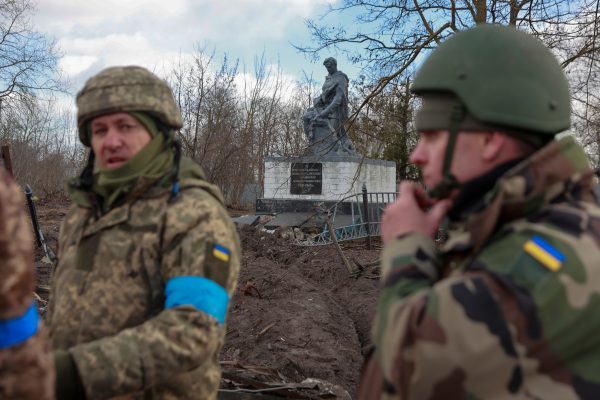 Published: Ukrainian service members stand near a damaged memorial to fallen WWII soldiers, as Russia's attack on Ukraine continues, in the recently liberated village of Lukianivka, in Kyiv region, March 27, 2022. Credit: REUTERS/Serhii Nuzhnenko