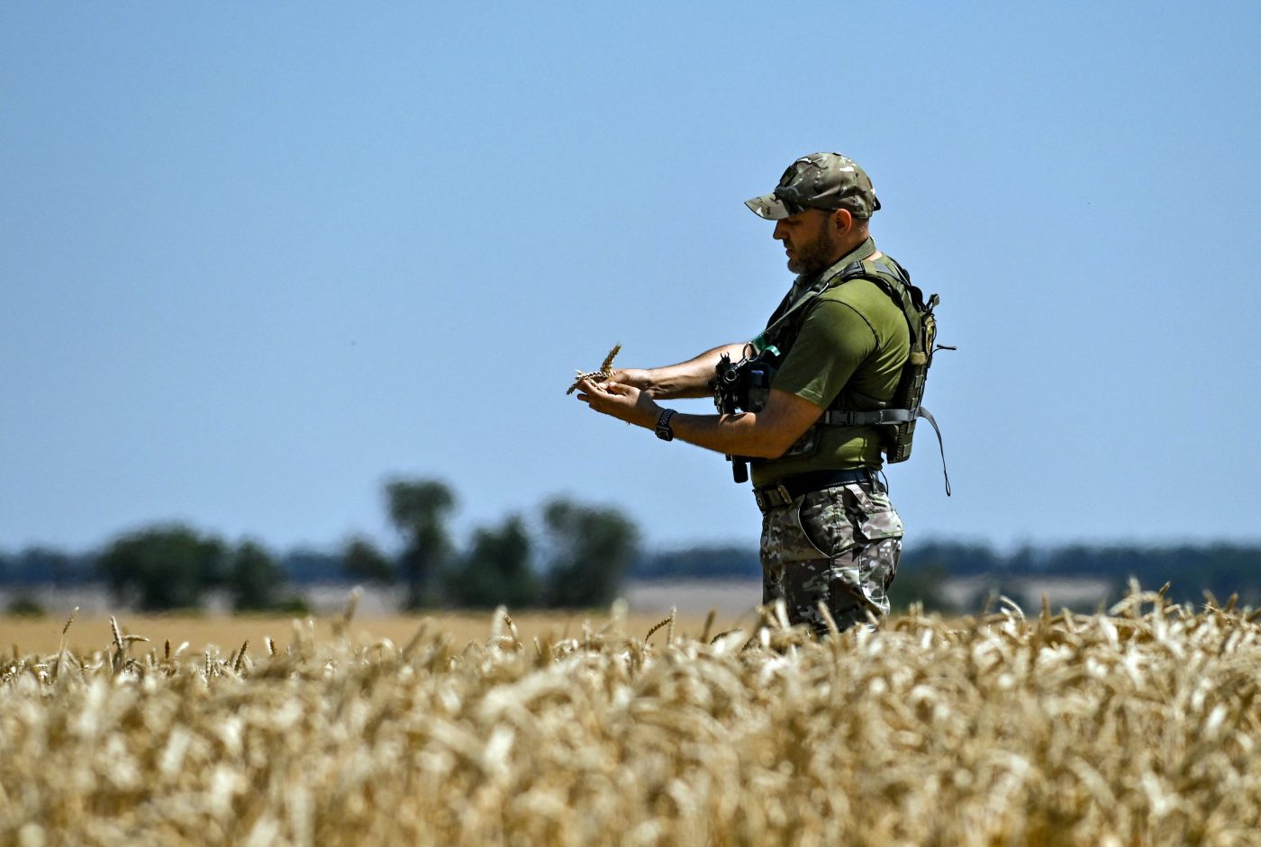 Photo: Zaporizhzhia Region, Ukraine - July 17, 2022 - A serviceman holds wheat ears during the harvest season, Zaporizhzhia Region, southeastern Ukraine. This photo cannot be distributed in the Russian Federation. Credit: Photo by Dmytro Smolyenko/Ukrinform/ABACAPRESS.COMN