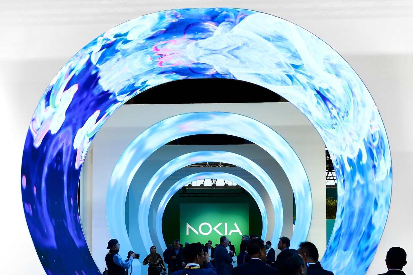 Photo: BARCELONA, SPAIN - MARCH 2: Congress visitors passing by the entrance of the Nokia stand that featured the new redesigned logo. The Finnish company announced the rebranding and the change on their logo, the first in 60 years, to let customers know that they not only make phones, but they also have a huge role on networks and industrial digitalization during the Mobile World Congress 2023 on March 2, 2023, in Barcelona, Spain. Credit: Photo by Joan Cros/NurPhoto