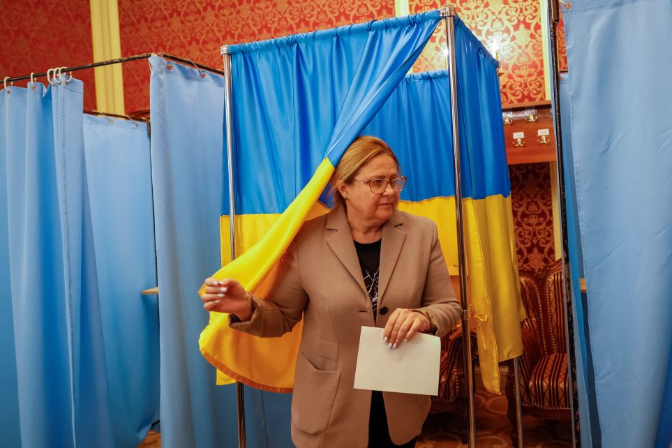 Photo: A person votes, as members of an emergency plenary session of the Supreme Court of Ukraine hold a no-confidence vote for Chief Justice Vsevolod Kniaziev, who has been detained by anti-corruption authorities for allegedly receiving a $2.7 million bribe, amid Russia's attack on Ukraine, in Kyiv, Ukraine, May 16, 2023. Credit: REUTERS/Alina Smutko