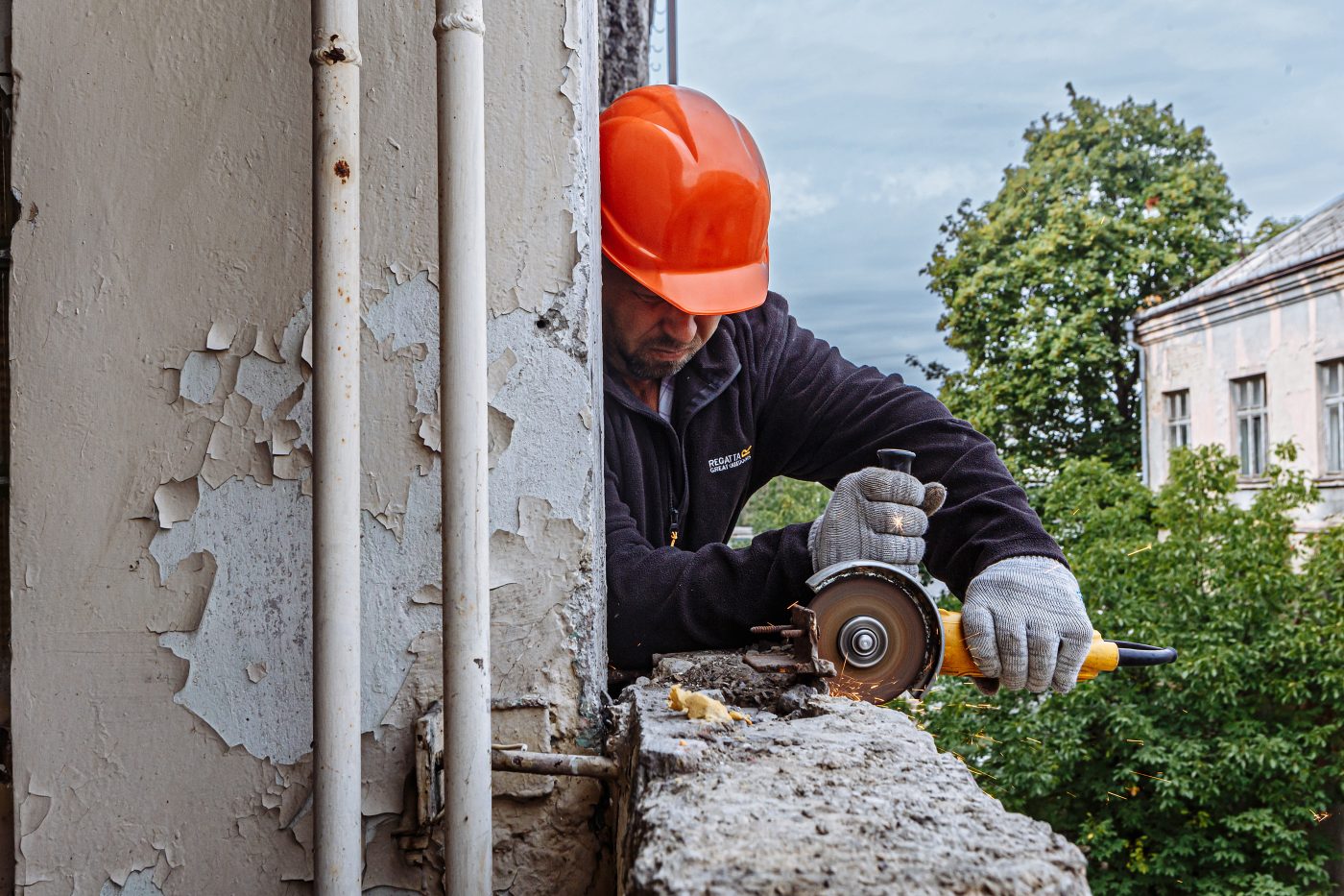 Photo: An employee of a construction company from Melitopol works on conversion of the office space of the former Tysa engineering plant into residential apartments, Uzhhorod, Zakarpattia Region, western Ukraine. Credit: Serhii Hudak via Reuters Connect