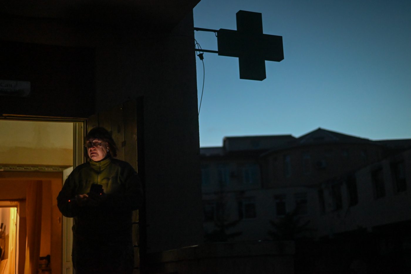 Photo: A nurse of the Ukrainian Armed Forces takes a short cigarette break at the entrance of the emergency room of a military hospital in Lyman on December 01, 2022. Ukrainian Armed Forces medics, doctors, and nurses stabilize wounded servicemembers and civilians in a hospital in Lyman before patients are transferred to other medical facilities for further treatment. Lyman, Ukraine. Credit: Photo by Justin Yau/ Sipa USA
