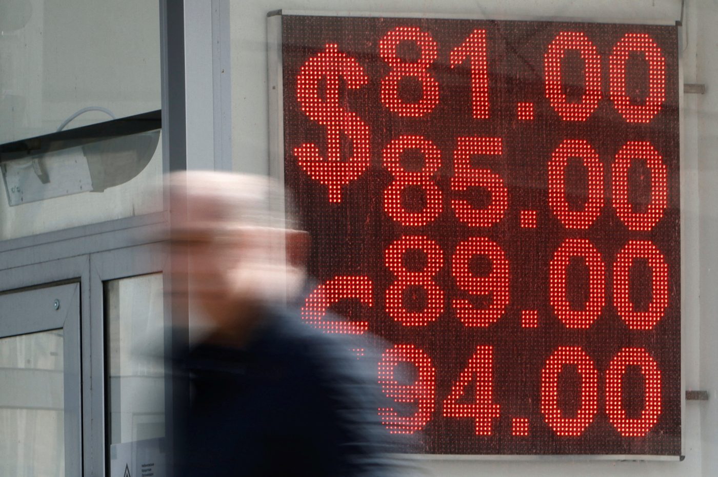 Photo: A man walks past a board showing currency exchange rates of the Euro and the U.S. dollar against the Russian rouble in Moscow, Russia April 7, 2023. Credit: REUTERS/Maxim Shemetov