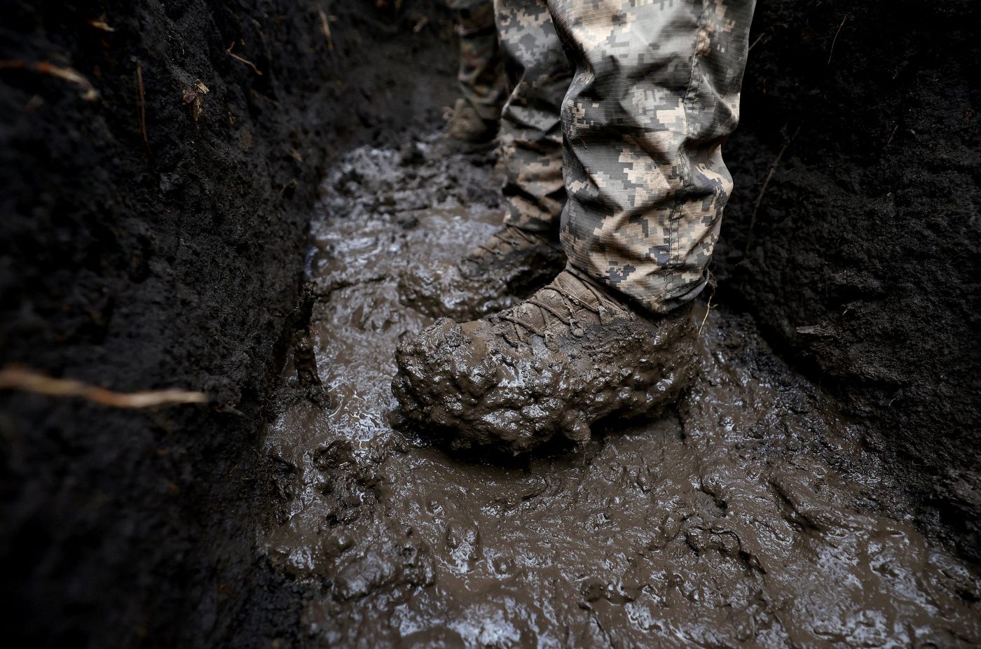 Photo: A Ukrainian serviceman of a fire platoon stands in mud in a trench near the frontline, as Russia's attack on Ukraine continues, in Donetsk region, Ukraine February 27, 2023. Credit: REUTERS/Lisi Niesner